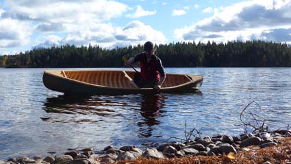 Paddling the wood and canvas canoe in the Swedish woods.